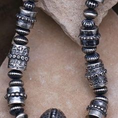 Handcrafted silver beads by Navajo artist Travis Teller. Made of solid sterling silver.The Teller family is renown for its silver smithing techniques in their chains and beads.Silver beads are a traditional art form of the Diné silversmiths.The beads have as many shapes and sizes as there are artisans. The traditional way of making beads is a time-consuming process. Each bead begins either with sheet silver or with silver that must rolled and cut. This particular set of beads is a wonderful example, a true collectors piece.  Measurements: 26" in length  / Center bead, approximately 38mm Silver Smithing, Making Beads, Metal Clay, Handmade Beads, Tucson, Traditional Art, Sterling Silber, Silver Beads, Favorite Jewelry