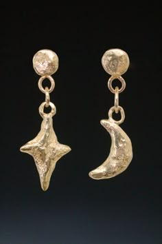 Sculptural star and and crescent moon charms hang on round links from little disc studs to make the perfect mismatched celestial earrings. Post style with friction ear nuts. Hand carved and cast in 14 karat yellow gold. One of a kind. Created by the artist, Miche McClendon, in her Laguna Beach studio/gallery. The moon is a symbol femininity, creativity, balance, change, growth and transformation. Specifically the crescent moon is known to symbolize fertility, intuitiveness, psyche, motherhood an New One Earrings, Star And Moon Jewelry, Witch Earring, Ancient Earrings, Star And Moon Earrings, Viking Earrings, Ancient Roman Jewelry, Beach Studio, Moon Earring