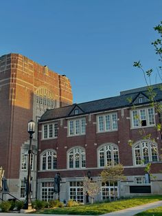 an old brick building with many windows and a clock tower