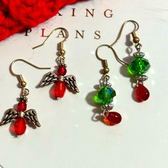 A 2 Piece Set Of Pretty Christmas Handmade Beaded Pierced Earrings Just In Time For The Holidays. Dainty Angel Drop Earrings Made Out Of Red Beads And Silver Tone Wings And A Set Of Red And Green Bead Dangle Earrings With Silver Tone Spacers Tags: Handmade Beaded Jewelry, Christmas, Holidays, Dangle, Drop, Office, School, Holidays, Party, Date Night Pearl Earrings Handmade, Turquoise Bead Earrings, Rectangular Earrings, Metallic Christmas, Bead Dangle Earrings, Bead Frame, Mermaid Earrings, Earrings Handmade Dangle, Christmas Handmade