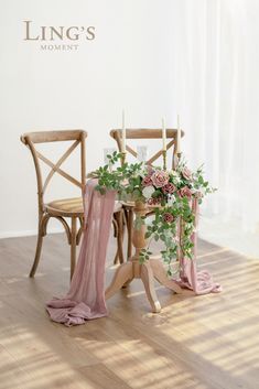 two chairs and a table with flowers on it