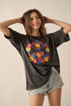 Distressed, mineral washed graphic t-shirt. Vintage-style floral peace sign graphic print. Torn and distressed detailing at neckline, cuffs, and hem. Round neckline. Short sleeves. Drop shoulder. Oversized fit. 100% Cotton. Imported top designed and printed in LA. Model wears size S. Floral Peace Sign, Distressed Graphic Tee, Peace Sign, Oversized Fits, Drop Shoulder, Graphic Prints, Round Neckline, Vintage Style, Graphic T Shirt