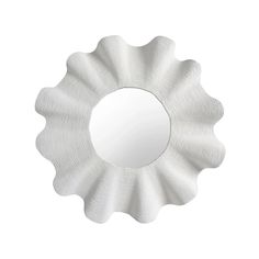 a white flower shaped mirror hanging on the side of a wall in front of a white background