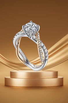 a diamond engagement ring on top of a stand