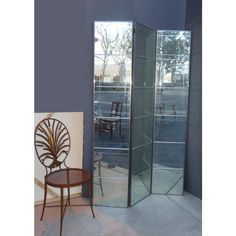 a chair sitting next to a tall glass door in a room with blue walls and flooring