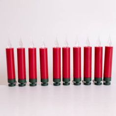 seven red candles lined up in a row