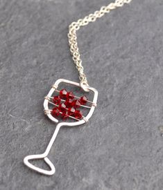 I'll have a glass of your finest red! Maybe you love the less-serious side of jewelry. Maybe you just love wine! I know I do. This hand-hammered necklace is sure to bring smiles and conversation wherever you go. Tiny Swarovski crystal beads strung on sterling silver wire stand in for your favorite red. The pendant is approximately 0.5 inches wide and approximately 1.25 inches long. Choose your chain length, or leave a note to seller if you would like a chain length other than those listed. All i Wine Jewelry, Wine Glass Necklace, Wood Wine Necklace, Adjustable Red Glass Necklace, Silver Wire-wrapped Necklace With Recycled Glass, Girls Weekend Gifts, Hammered Necklace, Hammered Bangles, Equestrian Jewelry