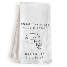 a white dish towel with a piece of cheese on it that says, sweet dreams are made of cheese who am i to dis a brie?