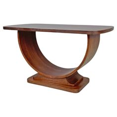 a wooden table with an oval shaped base and curved legs, on a white background