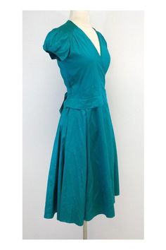 Size X-Small Deep Teal Wrap Dress Body 100% Silk Made in the USA Cap sleeves with elastic detail V neck Hits below the knee Wrap and tie waist for adjustable fit Underarm to underarm 18" Total length 42.5"