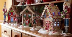 a shelf filled with lots of different types of gingerbread houses and candy canes