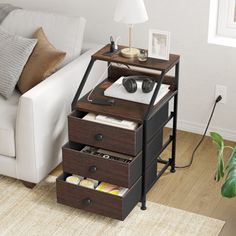 a living room with a white couch and coffee table next to a lamp on the floor