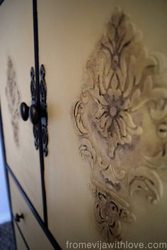 an ornate design on the side of a cabinet