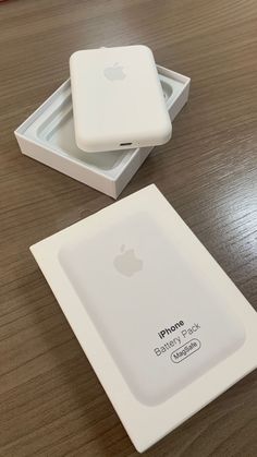 an apple product is sitting on the table with its box open and it's inside