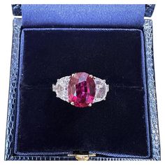 AGL CERTIFIED UNHEATED 3.03 carat Oval Ruby Three-Stone Ring in Platinum Oval Ruby Three-Stone Ring features an Oval Mixed cut Red Ruby accented by Two Half Moon cut Diamonds set in Platinum. The ruby originates from Mozambique and is unheated. Ruby weight is 3.03 carats and is AGL certified (please see copy of certificate in the photo gallery). The ruby measures 9.78 x 7.68 x 4.47 mm. Accenting the red ruby are two Half Moon cut Diamonds on the side. Total diamond weight is 1.80 carats. Ring is