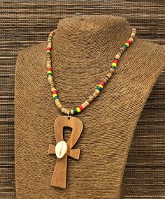 "Rasta Beaded Necklace. Natural Wood Ankh Necklace Pendant. Handmade Ankh Wooden Pendant. Unisex Design. Necklace is 17\" Inches Around the Neck Meaning of Ankh Cross: ancient symbol of life on Egypt Ankh Pendant Dimensions: 3\" Inches Long FAST & FREE SHIPPING! Visit my Etsy Shop to see more Handmade Africa Jewelry! At Freedom Life Style Jewelry you will find a variety of Africa Necklaces and Africa Earrings. Click here to see more designs: https://www.etsy.com/shop/FreedomLifeStyle" Bohemian Ankh Jewelry For Festivals, Bohemian Ankh Shaped Jewelry For Festivals, Handmade Ankh Necklace For Festivals, Bohemian Ankh Necklace For Festivals, Handmade Artisan Ankh Jewelry, Traditional Ankh Necklace For Gifts, Handmade Brown Necklaces For Rituals, Egypt Ankh, Africa Jewelry