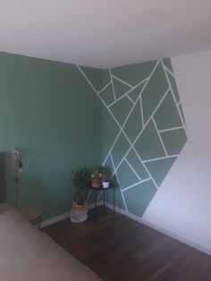 an empty room with green walls and wood floors