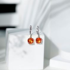 Product Details Enhance your style with stunning Drop Earrings featuring cushion-cut created orange sapphire and lever back for a perfect combination. Effortlessly infuse glamour into any outfit, making a vibrant statement that turns heads and garners compliments. Product Information SKU SHP-EARRINGS052310126 Weight 2.00 gm (Approximate) LAB CREATED ORANGE SAPPHIRE INFORMATION No.of Stones 2 Pieces Total Weight 5.50 Carat (Approximate) Dimension(approx) Cushion-8X8 mm-2 Pcs Color Orange Cut Bril Orange Cut, Sapphire Solitaire, Orange Sapphire, Signature Jewelry, Outfit Making, Timeless Jewelry, Conflict Free Diamonds, Cushion Cut, Free Jewelry