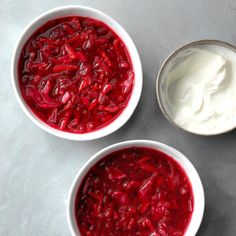 three bowls filled with yogurt sitting on top of a gray counter next to each other