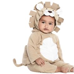 a baby in a lion costume sitting on the floor