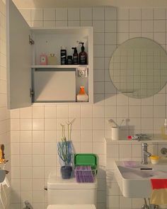 a bathroom with white tile walls and floor