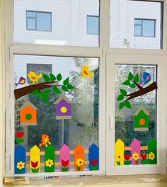 the window is decorated with colorful birds and houses