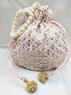 "beautiful golden tubes and pearl beaded embellishment baby pink fabric hand bag for women | bridal party velvet evening bag Package Contents: As per quantity purchased Size: 10\" x 8\" Designed with the heart, this beautiful Potli or batawa bag are eye catchy and made of premium material. Key Features: Embroidery art work This potli is good match with both Indian and western outfits and are superb for wedding and festive parties. This would be best complement to your designer saree, lenhga or a Unique Clutch, Hand Bags For Women, Boho Handbags, Vintage Evening Bags, Diy Bag Designs, Everyday Handbag, Fabric Handbags, Bridal Clutch, Fancy Bags