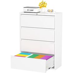 a white filing cabinet with three drawers and a printer on the top shelf next to it