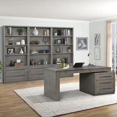 an office with gray bookcases and wooden floors