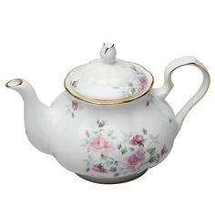 a white tea pot with pink flowers on it and gold trimmings around the top