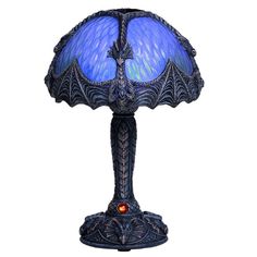 a blue lamp with an intricate design on the bottom and red light in the middle