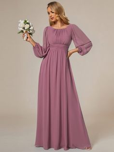 a woman in a long purple dress holding flowers