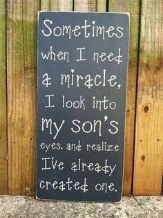 a wooden sign that says sometimes when i need a mirror, i look into my sons eyes and really created one