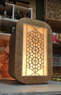 an intricate carved wooden box sitting on top of a table next to other woodworking supplies