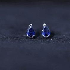 Product Details Elevate your style and stay on-trend with our stunning Solitaire Teardrop Earrings. Each earring features a Pear Cut Created Blue Sapphire, exquisitely set in a half Bezel Setting. These understated yet beautiful stud earrings are the perfect accessory to showcase your elegance. With a range of metal options available, you can customize these earrings to perfectly complement your unique style. Make a fashion statement and adorn yourself with these timeless gems. Product Informati Blue Briolette Earrings For Formal Occasions, Blue Sapphire Pear-shaped Earrings, Blue Teardrop Earrings With Prong Setting, Teardrop Sapphire Earrings For Gift, Blue Pear-shaped Fine Jewelry Earrings, Blue Gemstone Teardrop Earrings For Formal Events, Sapphire Pear-shaped Fine Jewelry Earrings, Fine Jewelry Sapphire Pear-shaped Earrings, Ethical Sapphire White Gold Earrings