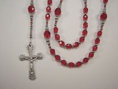 "July Birthstone! Great Gift!! This Beautiful Rosary is handcrafted with Faceted 6mm and  8mm Ruby Red Czech Glass Beads.  Genuine Czech Faceted Glass Beads. Ruby Red Czech Glass Seed Beads. The Rosary is 19 1/4\" from top to bottom of Cross.  ( Laid flat )  The picture do not capture the shine and sparkle of the beads! Flared Edge with Roses Crucifix This beautiful flared edge crucifix is intricately designed with tiny roses on the ends. Made in Italy, die cast with a nice silver oxidized finish and is 1 5/8\" long. Mother Mary / Sacred Heart Jesus Centerpiece This Beautiful Center features an embossed image with  a profile of our Mother Mary on the front  and an embossed image of the Sacred Heart Jesus on the back.  Made in Italy, silver oxidized and 7/8\" inch long. Handcrafted with Hig Blue Rosary, Beautiful Rosary, Beading Wire, Crystal Ab, July Birthstone, Red Bead, Faceted Glass, Pink Pearl, Blue Bracelet