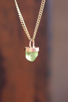 This pendant features a lovely, naturally terminated peridot crystal. The 7+ ct crystal is paired with a 14k yellow gold handmade bezel cap and bale pendant setting created by me in my studio here in Tucson,AZ. This is a really nice piece! The crystal glows in the sunlight with strong, glowing and saturated 🍏 green apple coloration. It has a lovely shape and nice termination. Fantastic! The gold bezel and bale have a rustic hand filed finish.   please note: this listing is for the pendant only; no chain included  Returns of purchased items, without damage and in like new condition, are welcomed within the specified timeframe.  For all purchases after November 14, 2023, returns will be subject to a $15 restocking fee, and buyer is responsible for return shipping. Untreated Recycled Gold Jewelry As A Gift, Untreated Recycled Gold Jewelry Gift, Recycled Gold Untreated Jewelry As A Gift, Gold Prehnite Jewelry As A Gift, Green Birthstone Jewelry In Recycled Gold, Green Recycled Gold Jewelry For May Birthstone, Green Recycled Gold Jewelry For Gift, Golden Sparkle, Peridot Crystal