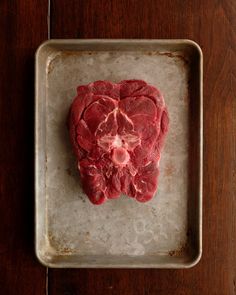 raw meat in the shape of a heart on a baking sheet