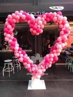 a heart shaped balloon display in front of a restaurant