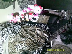 a bed covered in lots of stuffed animals on top of it's headboard