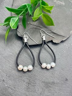 The genuine black leather with beautiful white freshwater pearls makes these Southwestern-style teardrop earrings a great addition to any collection. Lightweight with silver findings, they are the perfect accessory to add chicness to any outfit and complement almost everything. EARRING FEATURES Lightweight Total Length: 2.25 inches Material: Genuine Black Leather & Freshwater Pearls ♥ All orders come beautifully hand-packaged with care, making it the perfect gift for yourself or someone special. ♥ Each piece is handmade with love in my home studio in Rockaway, NJ. Leather Teardrop Jewelry, Everyday Leather Teardrop Earrings, Bohemian Teardrop Pearl Earrings With Ear Wire, Elegant Teardrop Leather Jewelry, Elegant Leather Earrings With Ear Wire, Handmade Adjustable Teardrop Pearl Earrings, Adjustable Nickel-free Teardrop Pearl Earrings, Black Dangle Pearl Earrings, Adjustable Teardrop Pearl Earrings In Minimalist Style