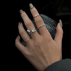 a woman's hand with two rings on her finger and a ring in the middle