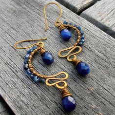 the earrings are made with gold wire and blue beads