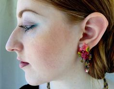 PINK LEMONADE DANGLE DROP EARRINGS. A cluster of pretty pink and green flowers covers the ear with a fringe of delicate drops that hang down creating a very sophisticated yet feminine look. We hand paint the resin flowers and hand sew them together with glass beads. This is a quality piece of jewelry that will last a life time. Created by designer Colleen Toland who has been creating her unique style of vintage jewelry for more than 30 years. Earrings measure 2 inches by .75 inches. All metal co Pink And Green Flowers, Purple Earrings, Hand Paint, Resin Flowers, Pink Lemonade, Life Time, Matching Necklaces, Green Flowers, Pretty Pink