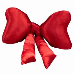 a red bow tie on top of a pillow