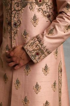 Peach sherwani with floral embroidered motifs and mandarin collar. Paired with kurta, pyjama.
Component: 3
Pattern: Embroidered
Type Of Work: Floral
Neckline: Mandarin
Sleeve Type: Full Sleeves
Fabric: Raw Silk, Cotton Silk
Color: Peach
Other Details: 
Floral embroidery
Note: Safa and kalangi worn by the model is not for sale
Occasion: Wedding,Groom - Aza Fashions Luxury Elegant Floral Embroidered Sherwani, Designer Floral Embroidery Sherwani With Long Sleeves, Spring Floral Embroidered Sherwani With Traditional Drape, Fitted Sherwani With Floral Embroidery, Semi-stitched Long Sleeve Sherwani With Floral Embroidery, Peach Sherwani, Embroidered Motifs, Kurta Pyjama, Full Sleeves