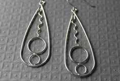 Gorgeous large sterling silver drop earrings and have different sized bubbles and squiggles. These would be a fantastic gift idea. They are made with sterling silver and love. They are tumbled to give them a lovely shine and harden them also. They have handmade French hook earring wire and it come in a gift box.Size- 2.5 inches long (3 inches including ear wire) / 7/8 inches wide **All pictures are close up shots to show details of the piece(s) PLEASE read description carefully for measurements. *Processing time on orders is within 2-5 business days (m-f) before your order will be shipped. Thank you so much for looking. ~Trina Freeform Sterling Silver Earrings As Gift, Sterling Silver Freeform Earrings As Gift, Elegant Silver Freeform Earrings, Handmade Modern Sterling Silver Earrings, Modern Wire Wrapped Sterling Silver Earrings, Modern Handmade Sterling Silver Earrings, Culottes Skirt, French Hook Earrings, Earring Wire