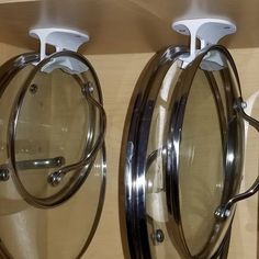 two circular mirrors mounted to the side of a wall