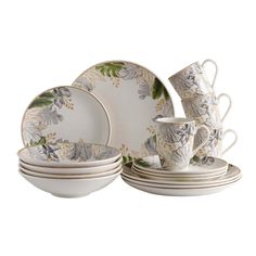 a white and green dinnerware set with flowers on the plates, cups and saucers