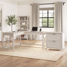 a white desk sitting on top of a hard wood floor next to a book shelf